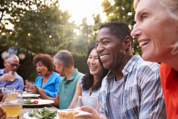Diverse group of people sharing a meal, representing inclusive Thanksgiving celebrations